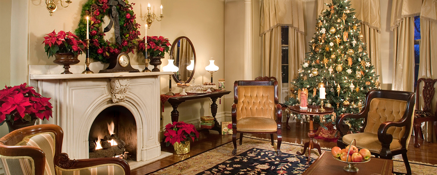 a brightly-lit bethlehem hotel lobby with a wood fireplace and christmas decorations