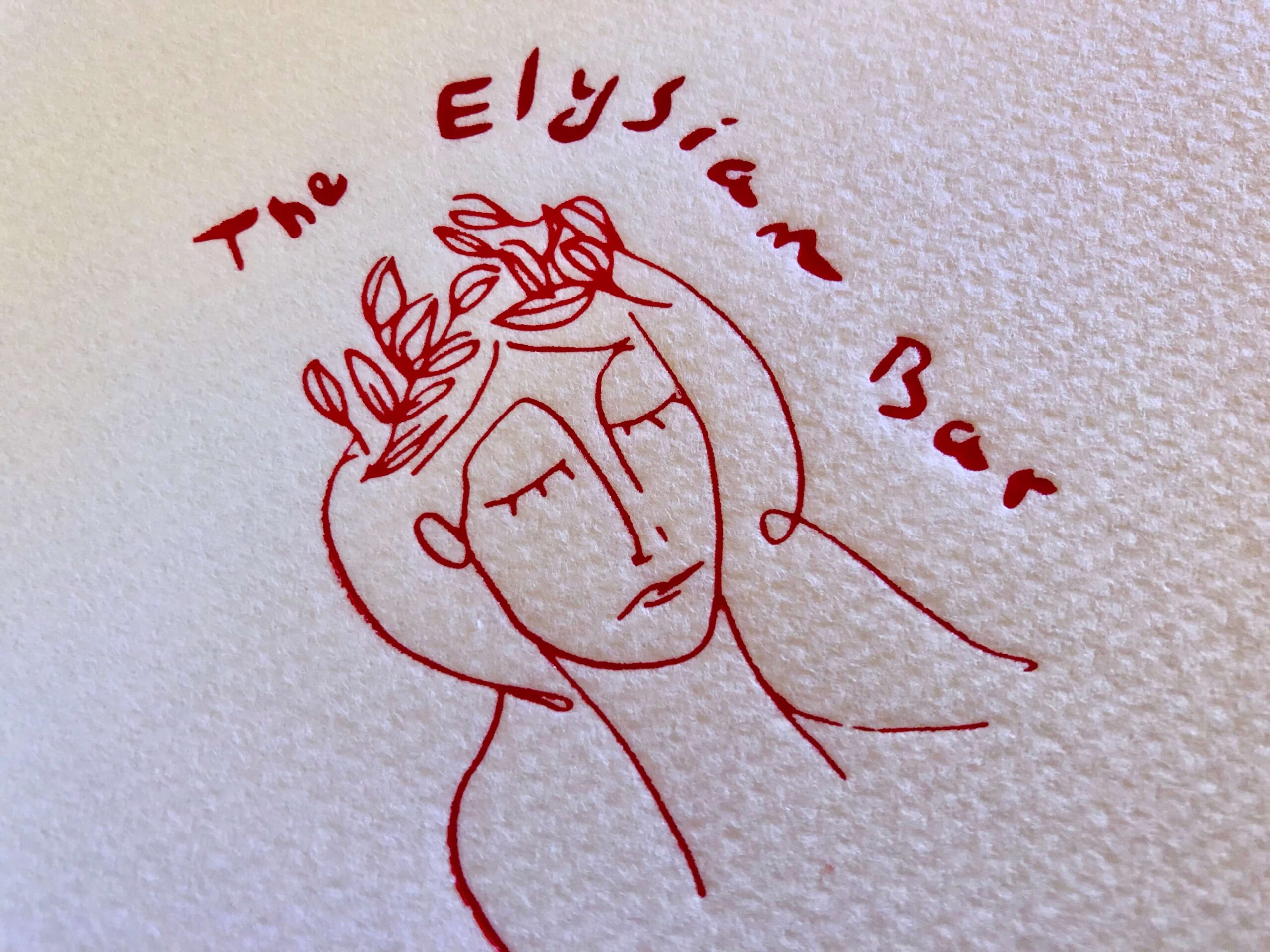 A cocktail napkin from The Elysian Bar