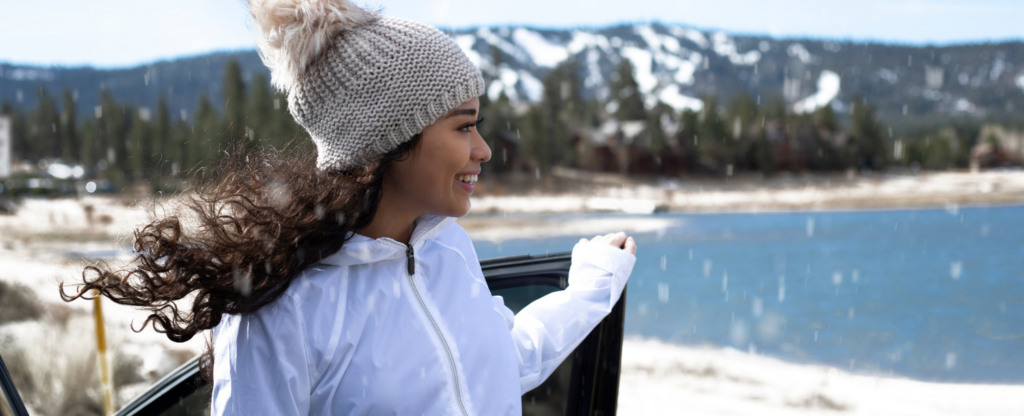 woman standing near car door in the snow