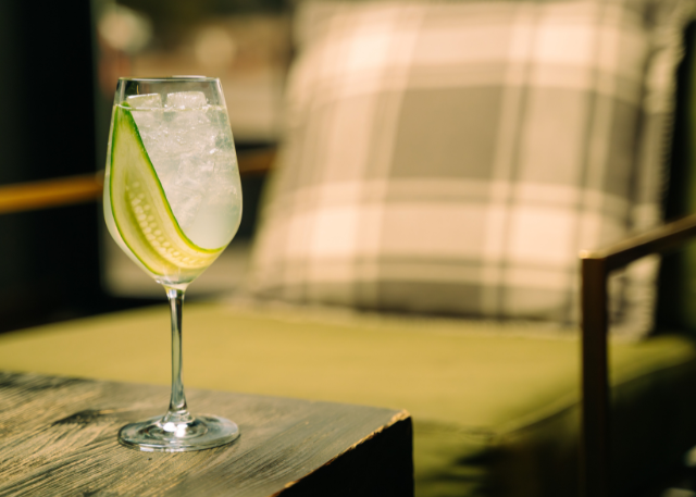 cocktail sitting on table with green chair in background