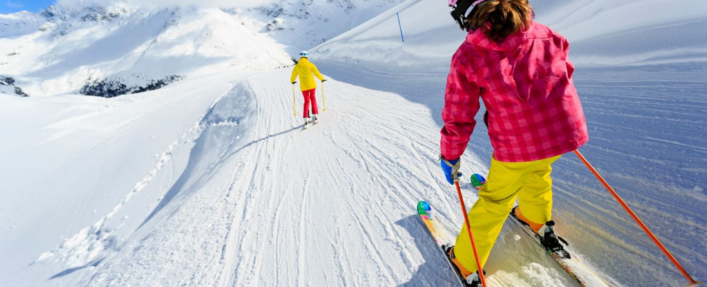 two people skiing down mountain