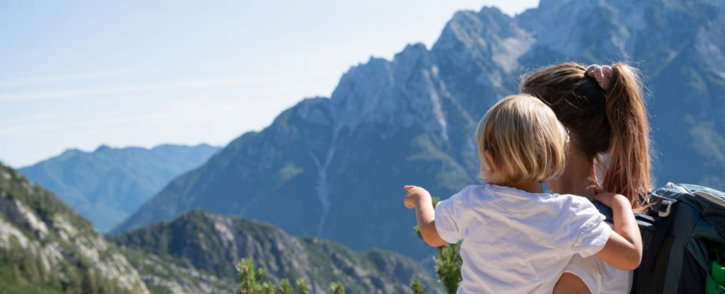 mother and child looking at mountains in big sky