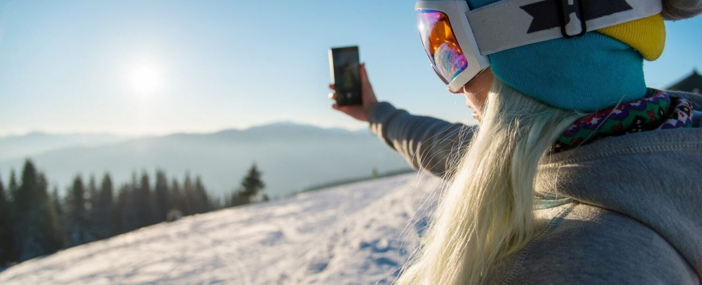 woman taking selfie in ski gear