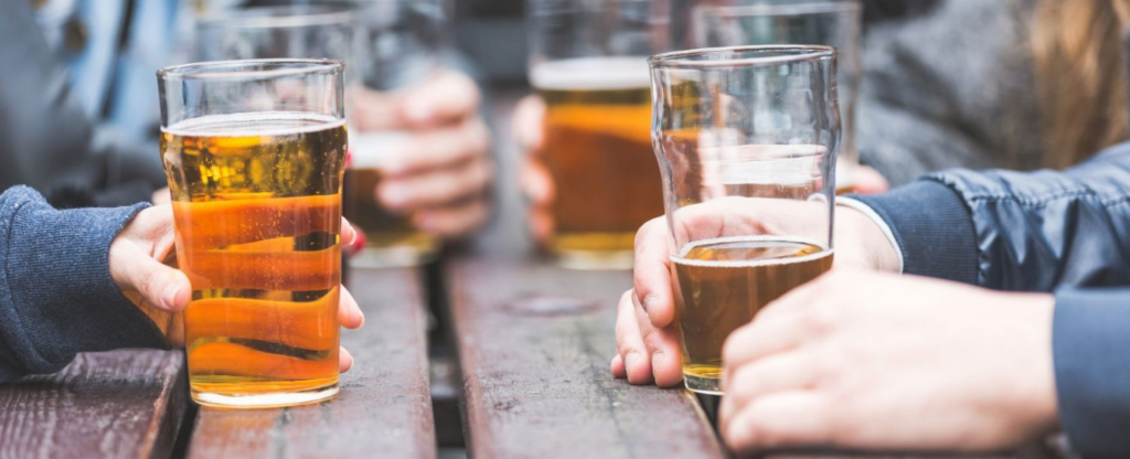 close up of people drinking beer