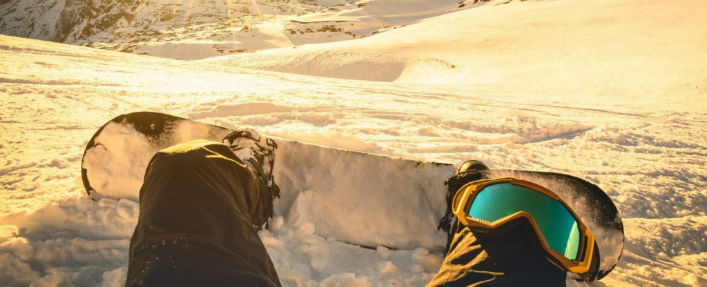 snowboard covered in snow on mountain