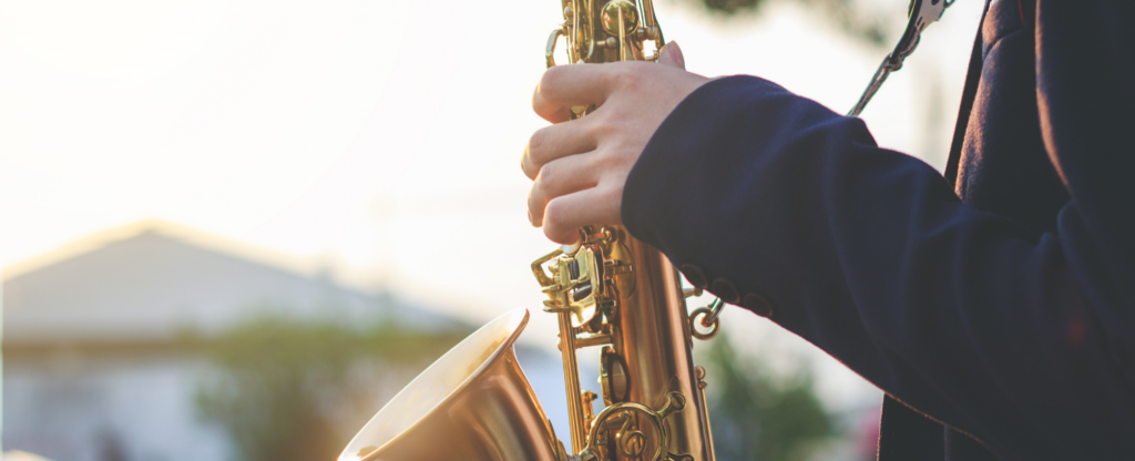 close up of person playing saxophone