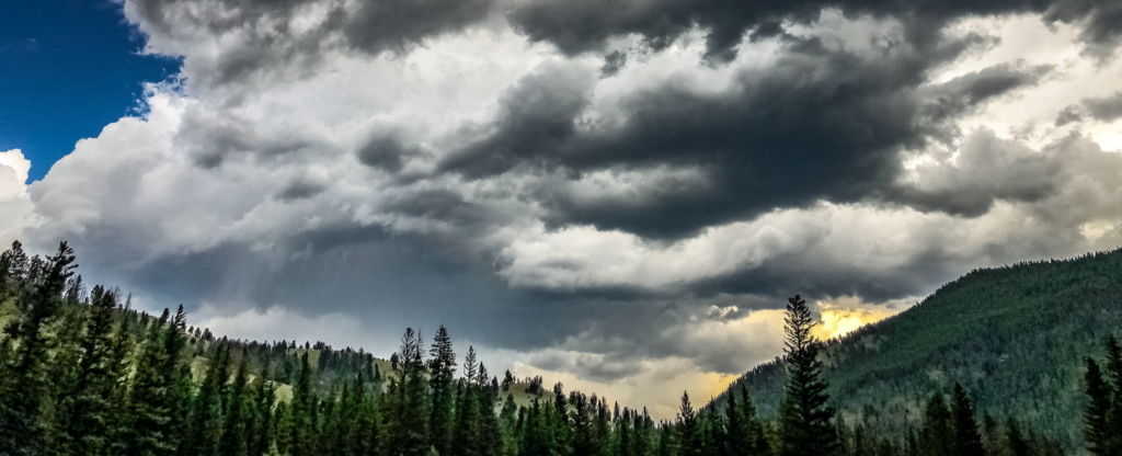 cloudy skies above a mountain range