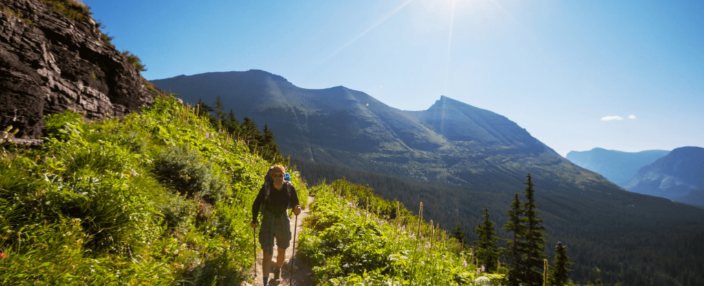 man hiking on side of mountain