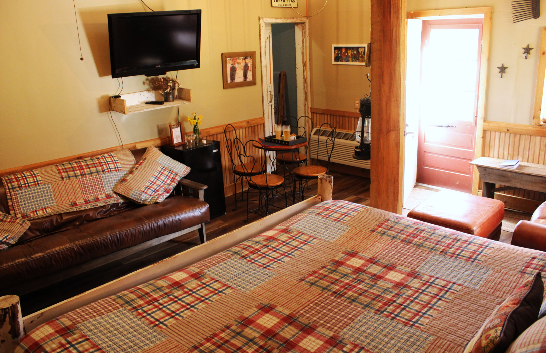 barn interior view from king bed of double leather futon and dinette table