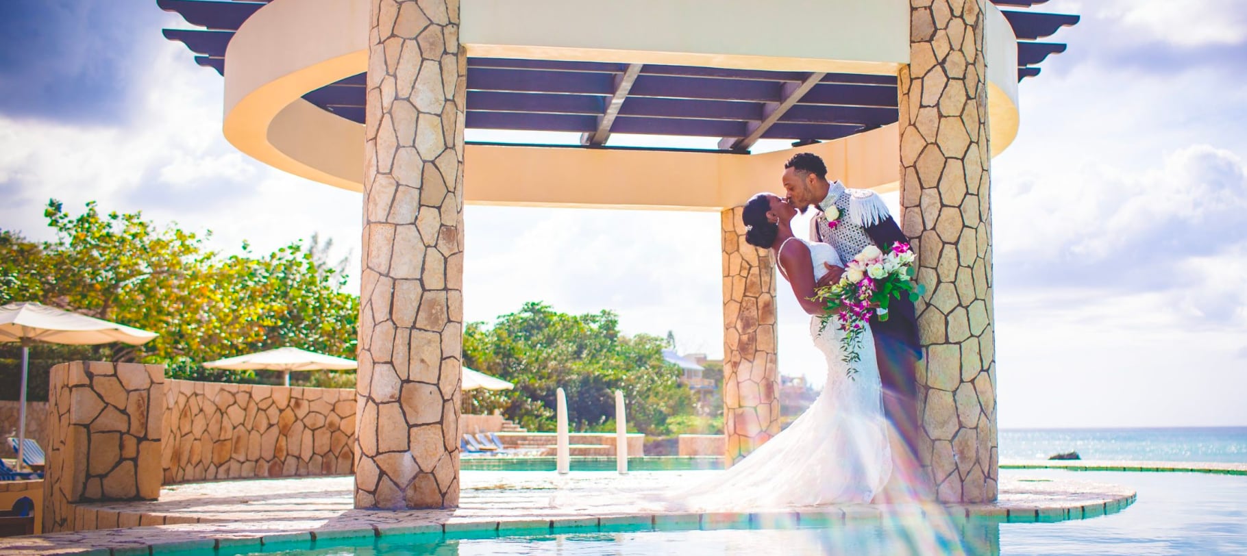 wedding couple kissing by pool