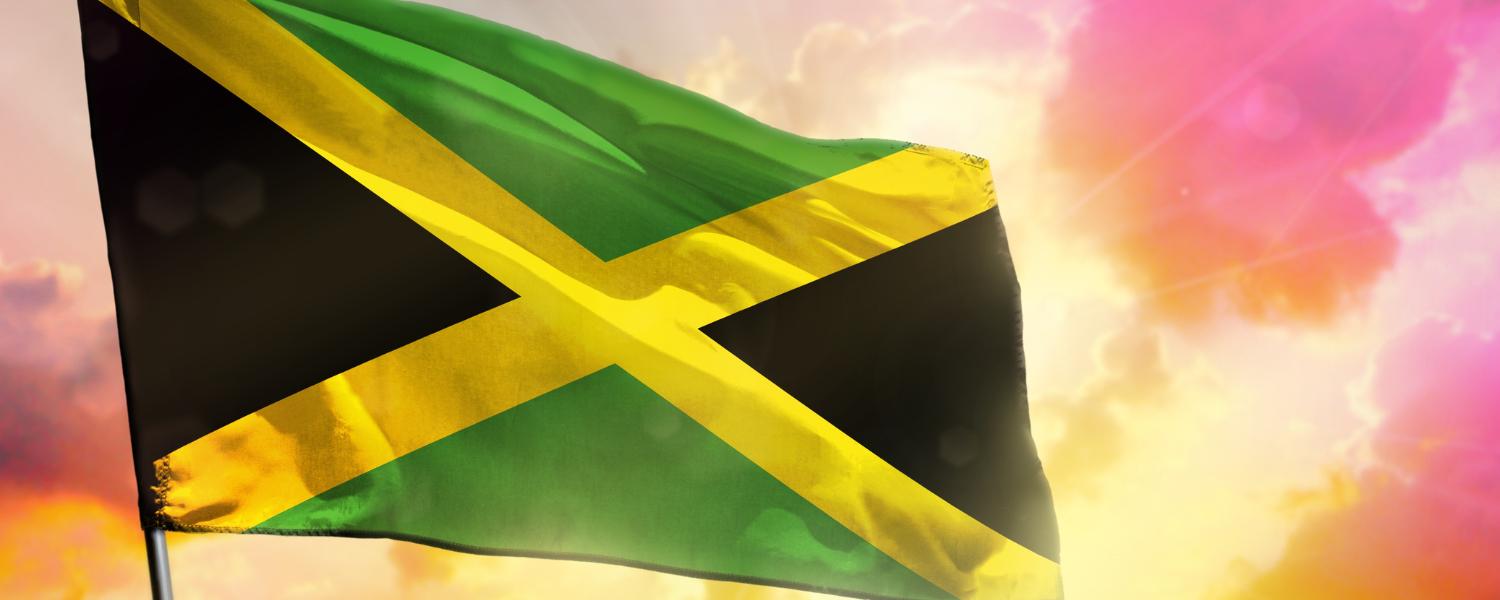 Jamaican flag with sunset in background