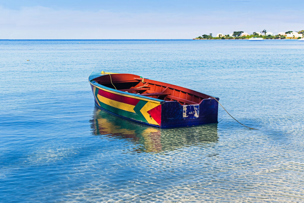 A colorful Jamaican boat floating along the shores of Bloody Bay, Negril.