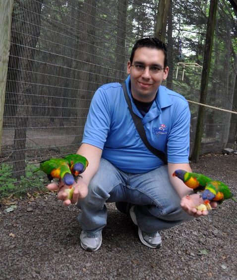 man holds parrots