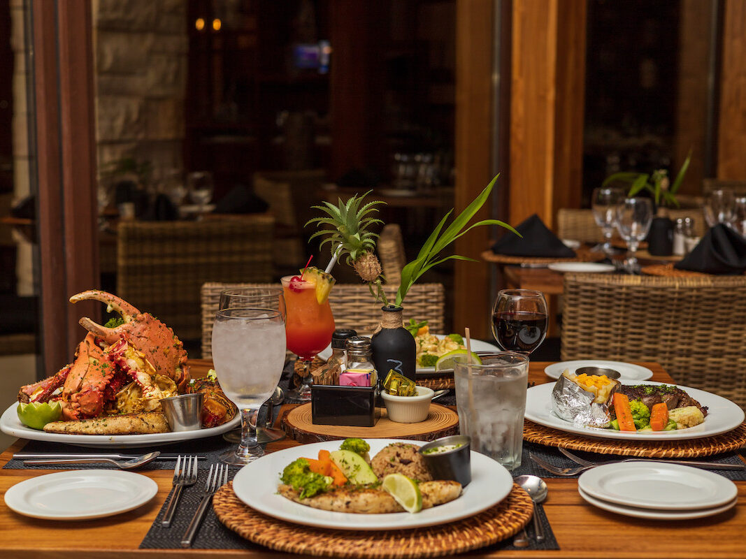 Dinner table at Anthony's Key Resort set with a variety of dishes and beverages.