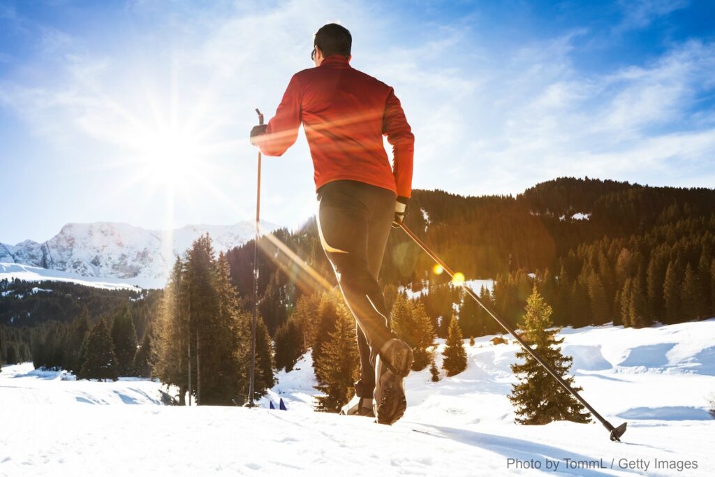 a man cross country skiing on a sunny, cold morning