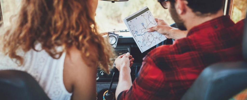 Couple traveling with map.