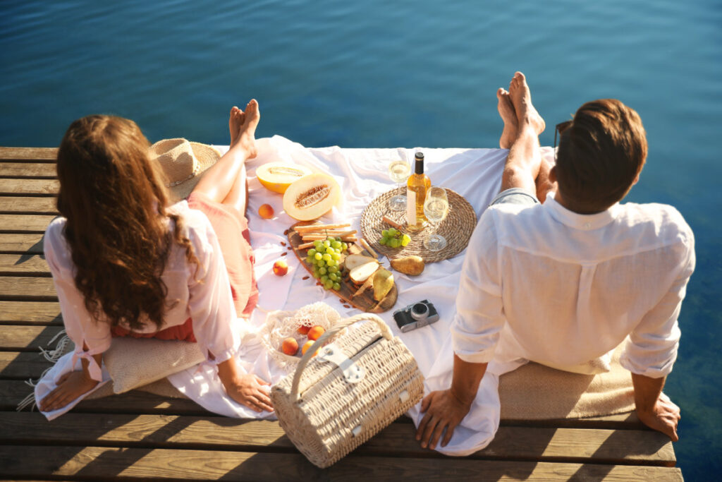 couple having a romantic picnic on dock