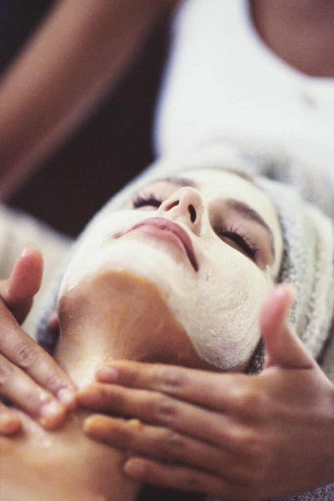Close-up of a young woman getting a facial treatme