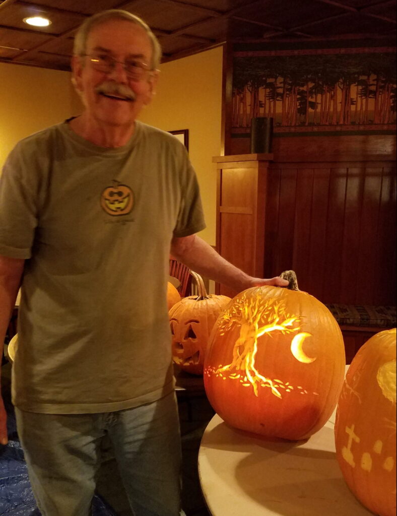 man with pumpkin carving