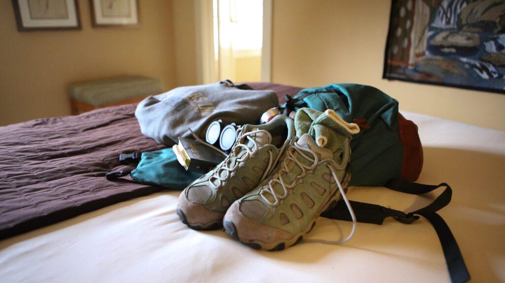 hiking equipment on bed