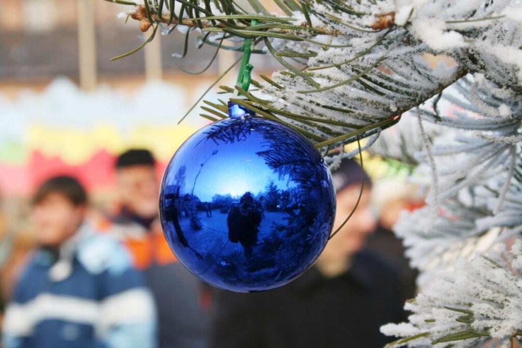 winter festival, picture of blue metallic ornament on outdoor christmas tree