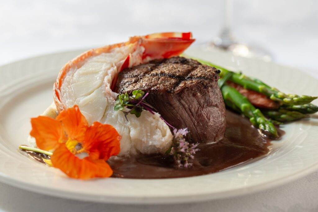 Steak and Shrimp Dinner with Flower on Plate