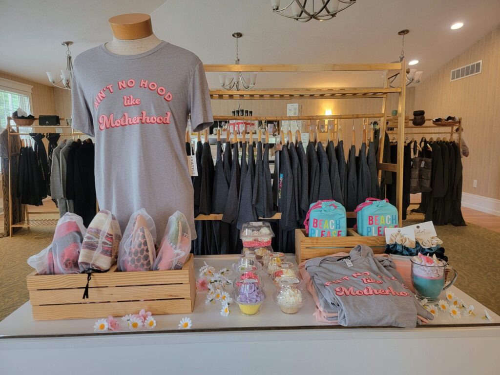 Shirts, candles, and slippers on display in boutique