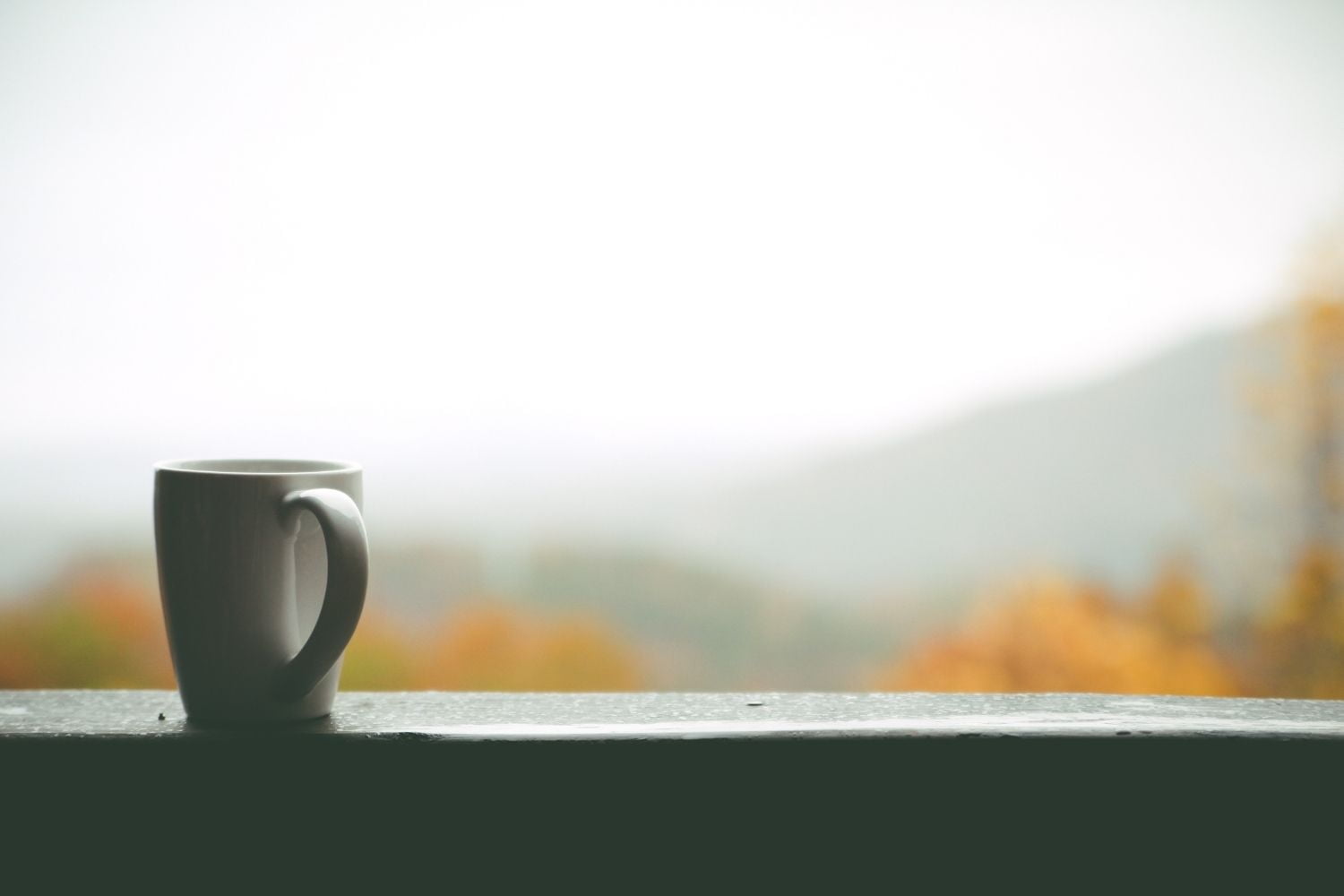 Coffee cup with mountain background.