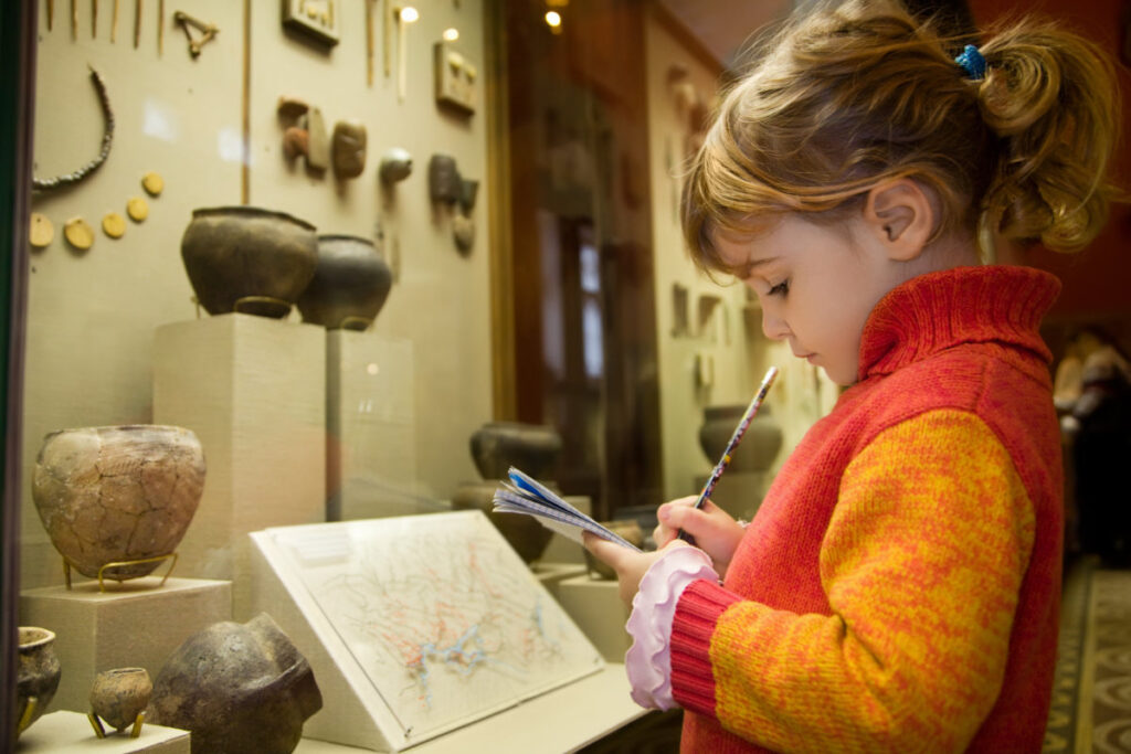 girl at museum glassed in exhibit