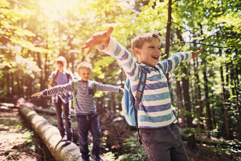 Kids hiking through the woods