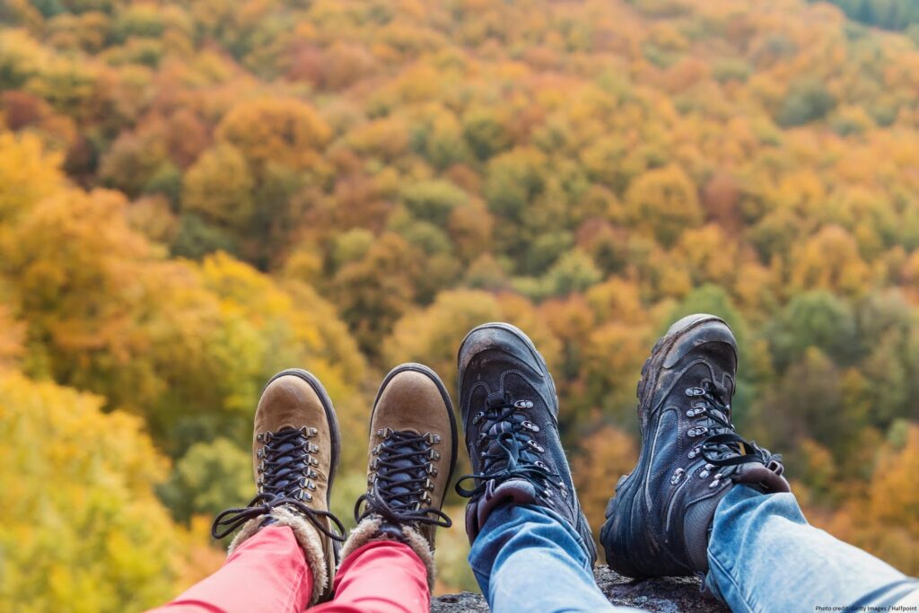 Unrecognizable young couple on a hike in autumn forest