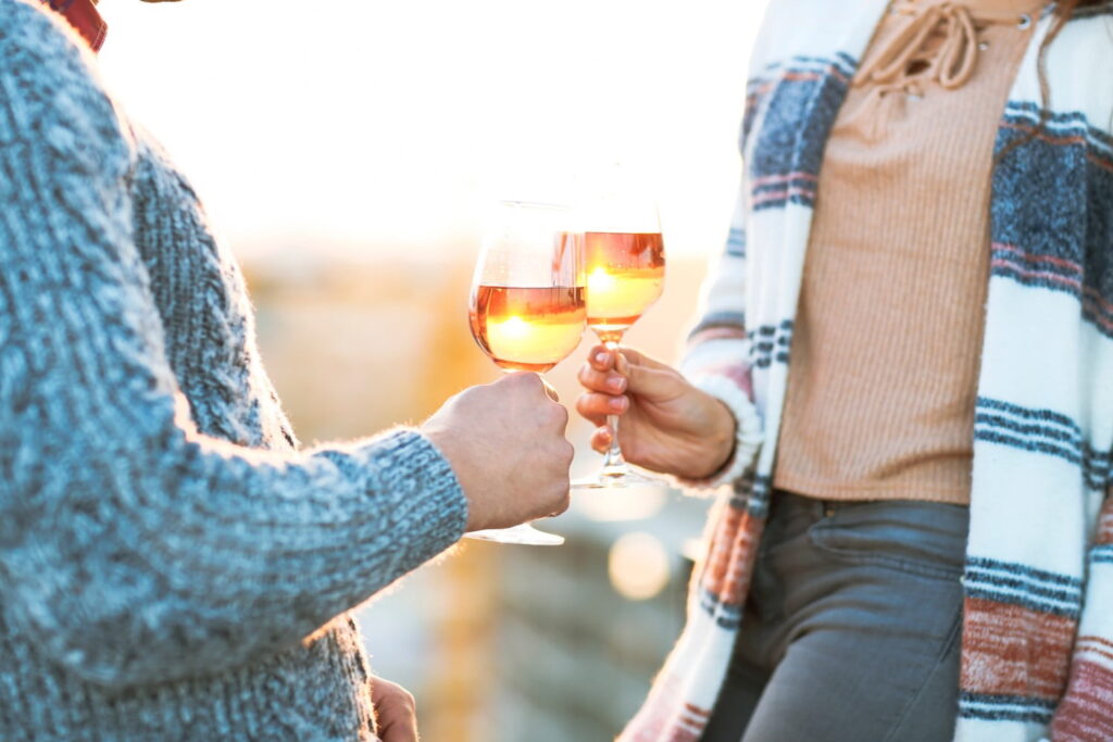 Man and woman with glass of rose wine at a fall festival